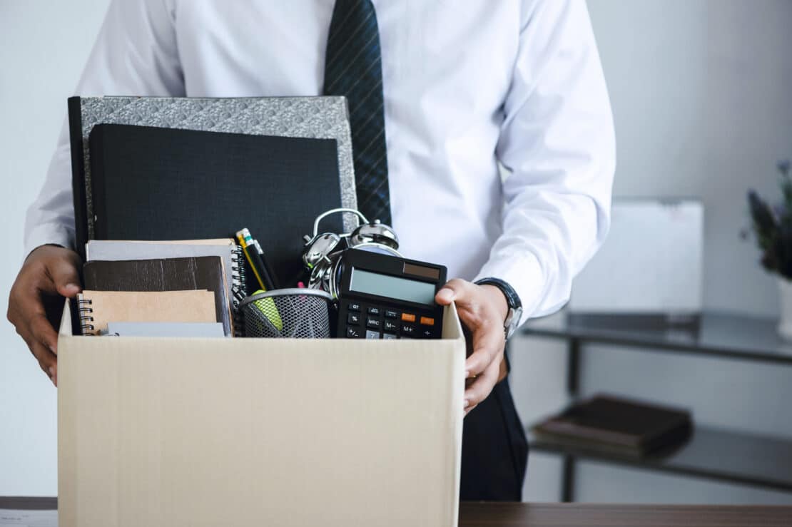 Stressed employee at desk considering resigning from a difficult job